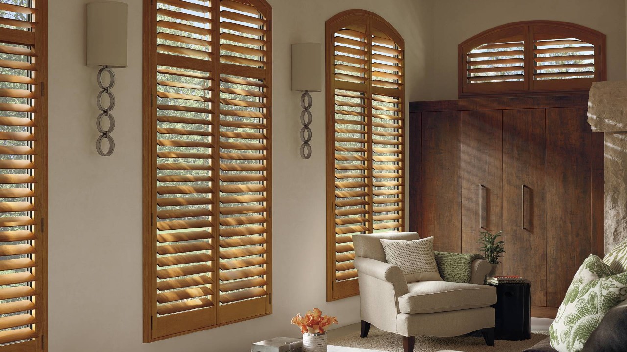 Hunter Douglas arched window shutters in a living room near Kenner, LA