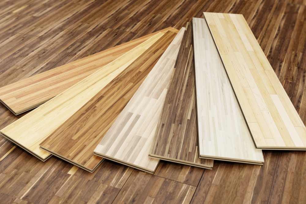 Sample panels of vinyl flooring fanned over darker vinyl flooring near Kenner, Louisiana (LA)