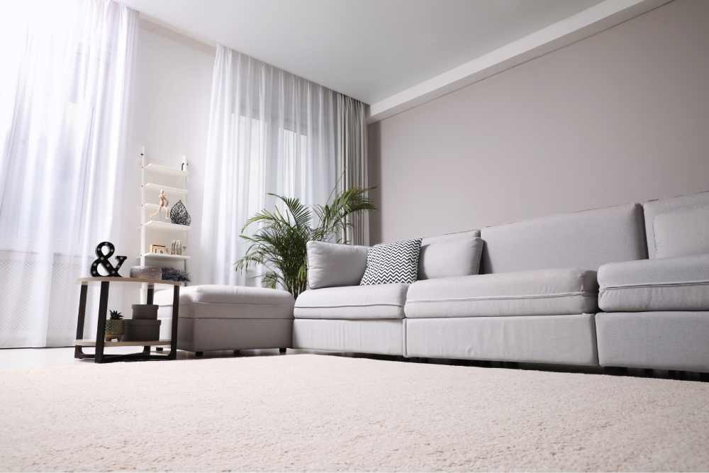 Light carpeting under a comfortable sofa in a living room near Kenner, Louisiana (LA)